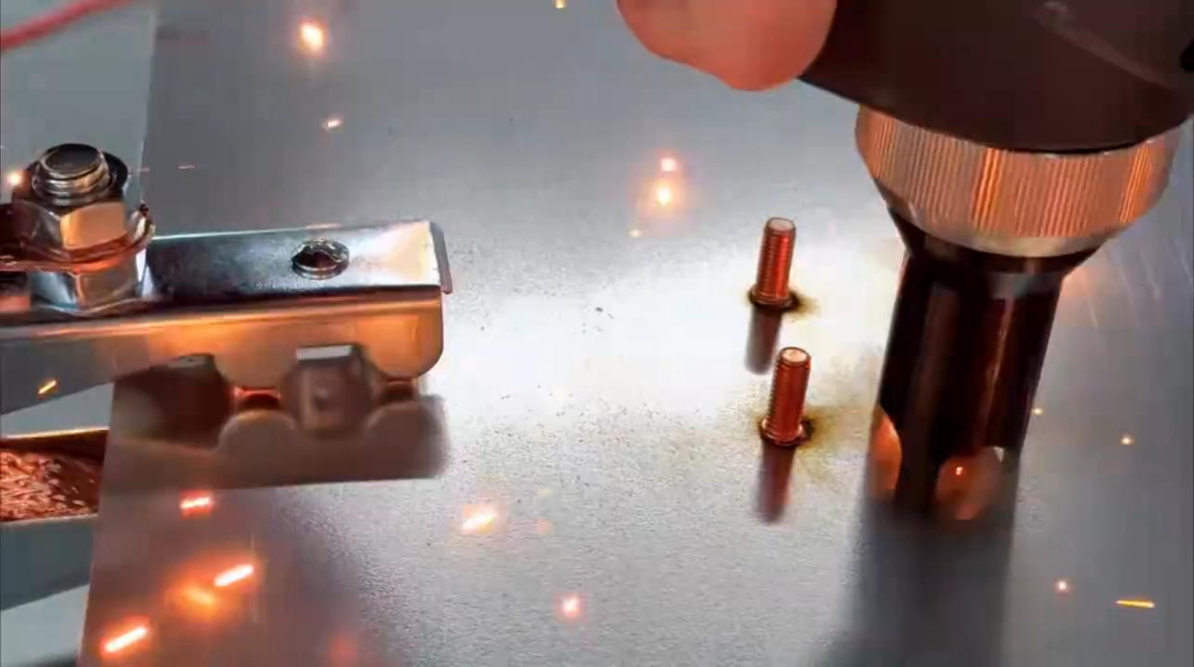 Main welding arc melting the end of a metal stud and the surface of a steel workpiece