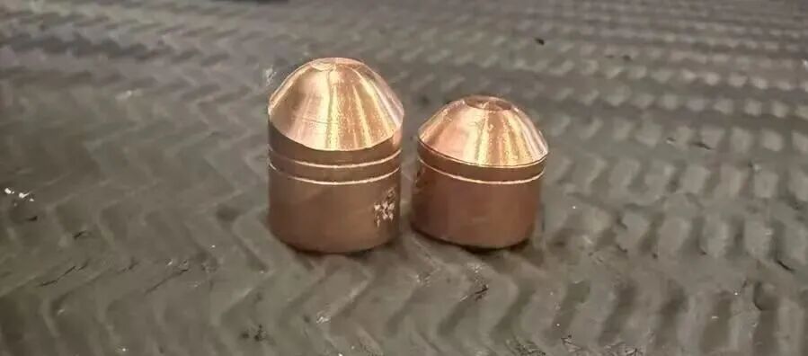 Upper and lower resistance spot welding electrode caps showing uneven projection after dressing.